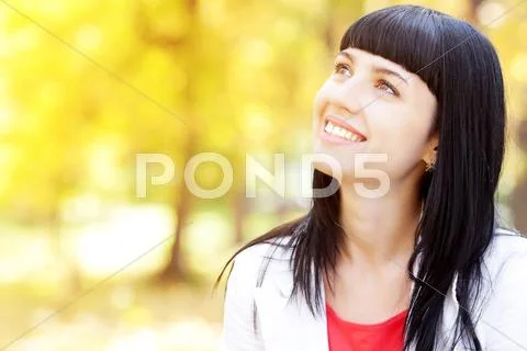 Portrait of a beautiful young woman in autumn forest Stock Photos