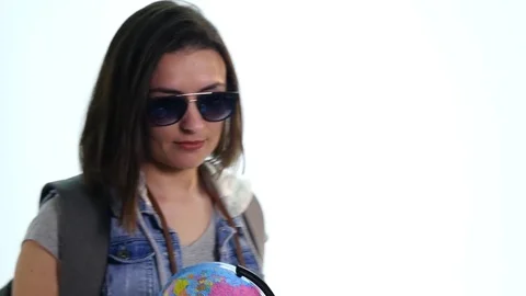 Portrait of beautiful young woman holding globe in hands against white Stock Footage