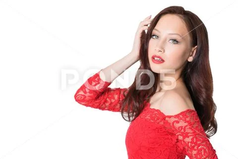 A portrait of a beautiful young woman in a red dress. Beauty, fashion. Stock Photos
