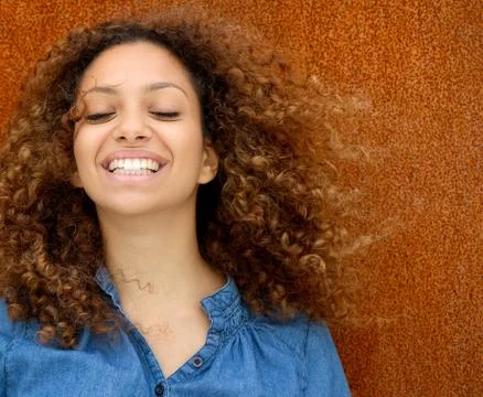 Portrait of a beautiful young woman smiling with curly hair Stock Photos