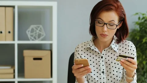 Portrait of beautiful young woman using smartphone for the online shopping Stock Footage 81114357