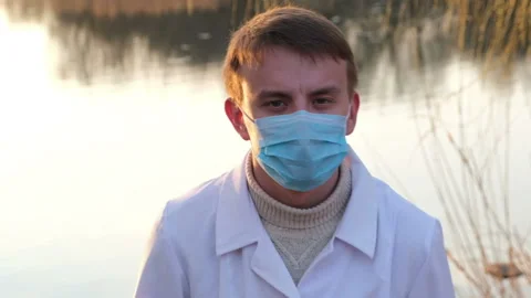 Portrait of a biochemist or environmentalist on the background of the lake Stock Footage 106345042
