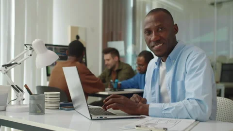 Portrait of Black Developer Posing at Office Desk with Laptop Stock Footage 277413373