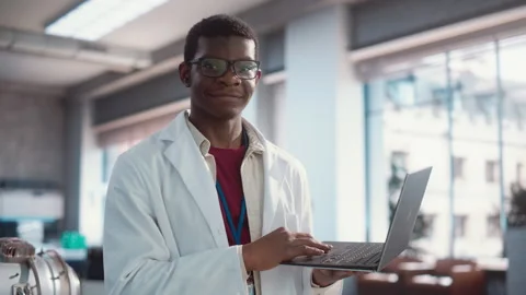 Portrait of Black Engineer with Laptop in Lab Looking at Camera Stock Footage 243255752
