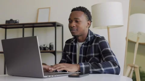 Portrait of a black guy talking on the video call. A relaxed, serious guy of Stock Footage 264116485