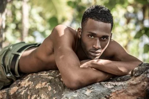 Portrait of black guy in the trees Stock Photos