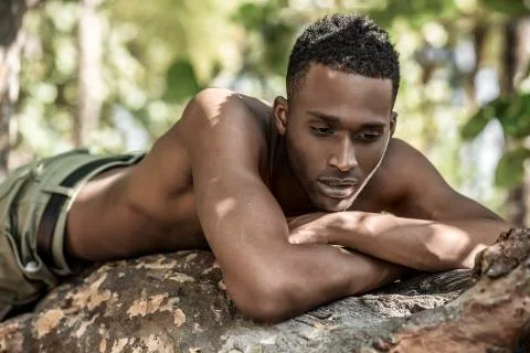 Portrait of black guy in the trees Stock Photos