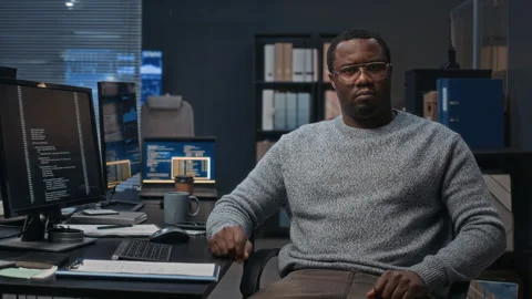 Portrait of Black Male Programmer Working at Desk with Multiple Monitors Stock Footage 324050554