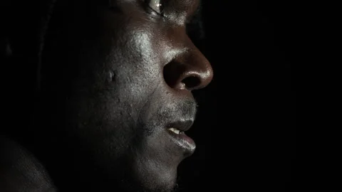 Portrait of Black Man Biting His Lip on Dark Background Stock Footage 298181438