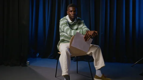 Portrait of Black Man Holding Script on Theater Stage Stock Footage 344528583