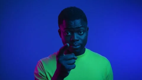 Portrait of Black Man Looking at Camera with Angry Gesture of Pointing Finger Stock Footage 272403975