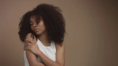 Portrait of black mixed race model in studio in beige background Video stock 84597481