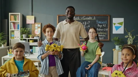 Portrait of Black Teacher and Multiethnic Students Holding Robotics Projects Stock Footage 340554010
