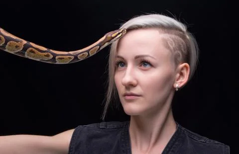 Portrait of blond woman with python Stock-Fotos