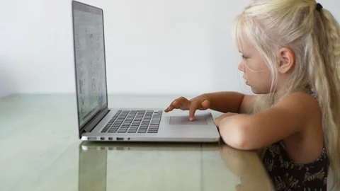 Portrait blonde baby use computer in sunny room rapid slow motion Stock Footage 87601434