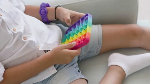 Portrait blonde boy with pop it sensory toy different forms. Stock-Footage 156867091