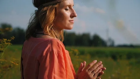 Portrait of blonde hippie dancing in a field with flowers. Woman in boho style Stock-Footage 151663805