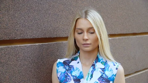 Portrait of a blonde on a wall background Stock Footage 120518758