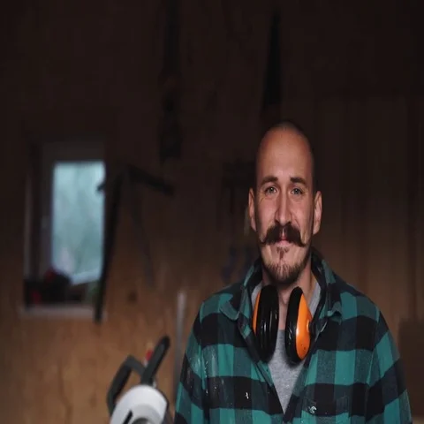 Portrait of a bold worker carpenter with vintage moustache in work clothes in Stock Footage 69540875