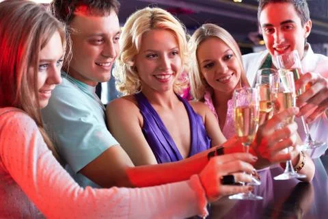 Portrait of boozing people in smart clothing toasting at party Stock Photos