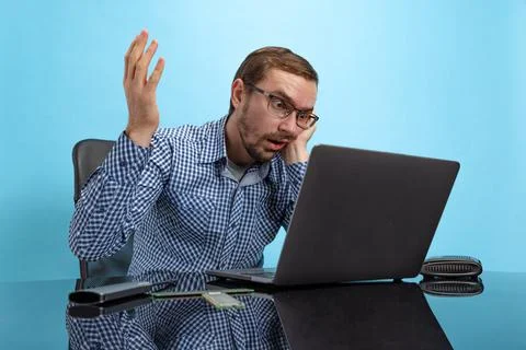 Portrait of bored tired man, programmer, call center operator sitting in front 스톡 사진