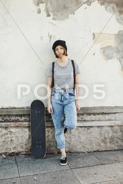 Portrait of boring young female skate boarder Stock Photos
