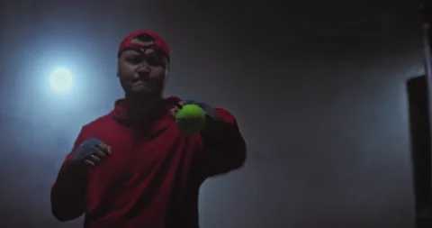 Portrait of a boxer doing a basic exercise with a ball, hitting the ball with Stock Footage 150003016
