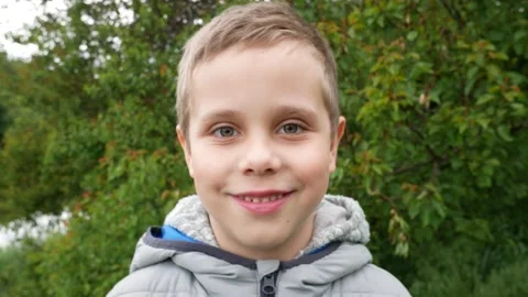 Portrait of a boy 6-7 years old against the background of nature Video stock 164875911