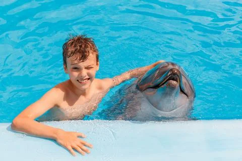 A portrait of a boy and dolphin Stock Photos