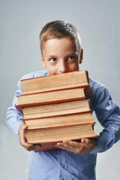 A portrait of a boy with big books Stock Photos