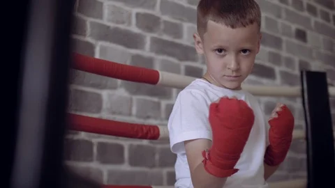 Portrait of boy boxer is wrapped with red bandages his hands. Stock Footage 111550265