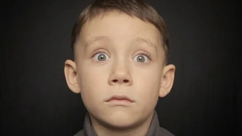 Portrait of a boy close-up on a black background. Full hd video Stock Footage 71584758