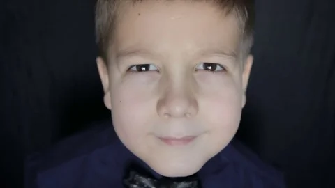 Portrait of a boy close-up on a black background. Full hd video Vídeo Stock 71782337