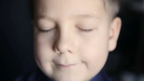 Portrait of a boy close-up on a black background. Full hd video Vídeo Stock 71782567