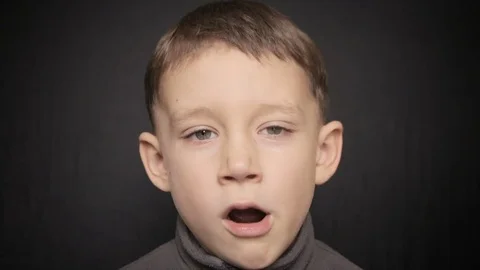 Portrait of a boy close-up on a black background. Full hd video Vídeo Stock 72100419