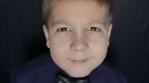 Portrait of a boy close-up on a black background. Full hd video Stock Footage 72510248