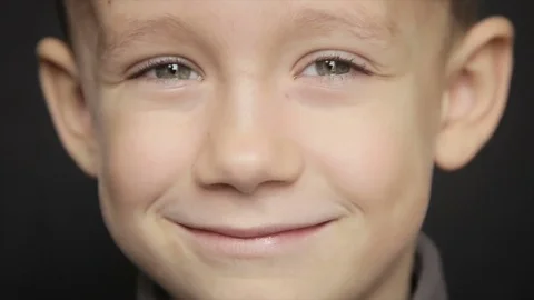 Portrait of a boy close-up on a black background. Full hd video Stock Footage 73596672