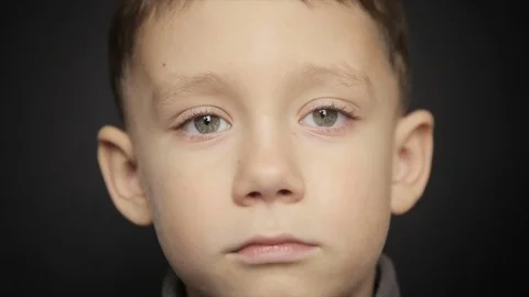 Portrait of a boy close-up on a black background Stock Footage 73597523
