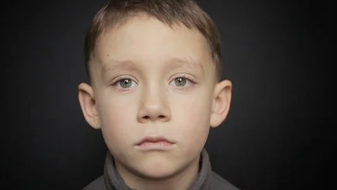 Portrait of a boy close-up on a black background Stock Footage 73597716