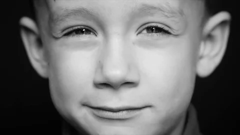 Portrait of a boy close-up on a black background Stock Footage 83595403