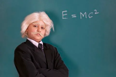 Portrait of boy dressed as Einstein with maths equation Stock Photos