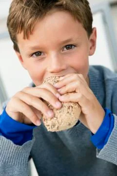Portrait of a boy eating a bun Stock Photos