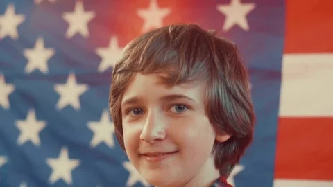Portrait of a boy in front of american flag. shot in slow motion Stock Footage 75781214