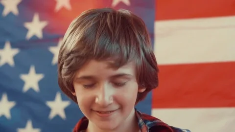 Portrait of a boy in front of american flag. shot in slow motion Stock Footage 75781699