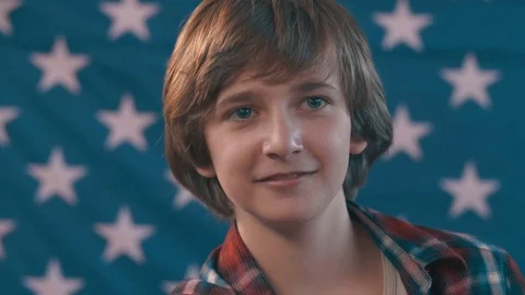 Portrait of a boy in front of american flag. shot in slow motion Stock Footage 75781796
