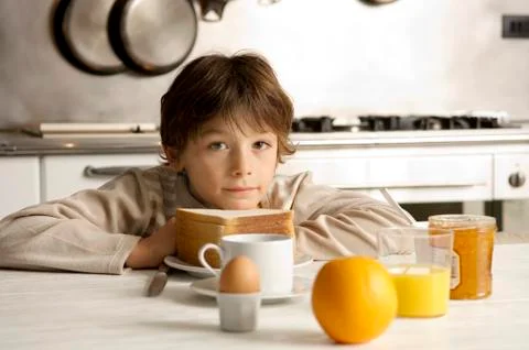 Portrait of a boy having breakfast Stock Photos