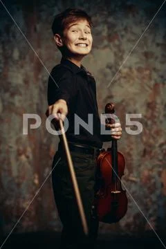 A portrait of a boy in his teens with the violin. A creative, talented, gifte Stock Photos