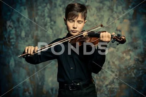 A portrait of a boy in his teens with the violin. A creative, talented, gifte Stock Photos