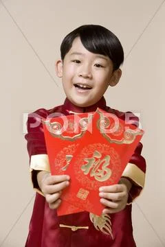 Portrait of a boy holding Chinese red envelop Stock Photos