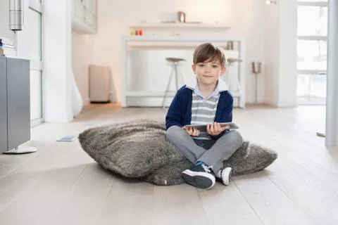 Portrait of a boy holding a digital tablet Stock Photos